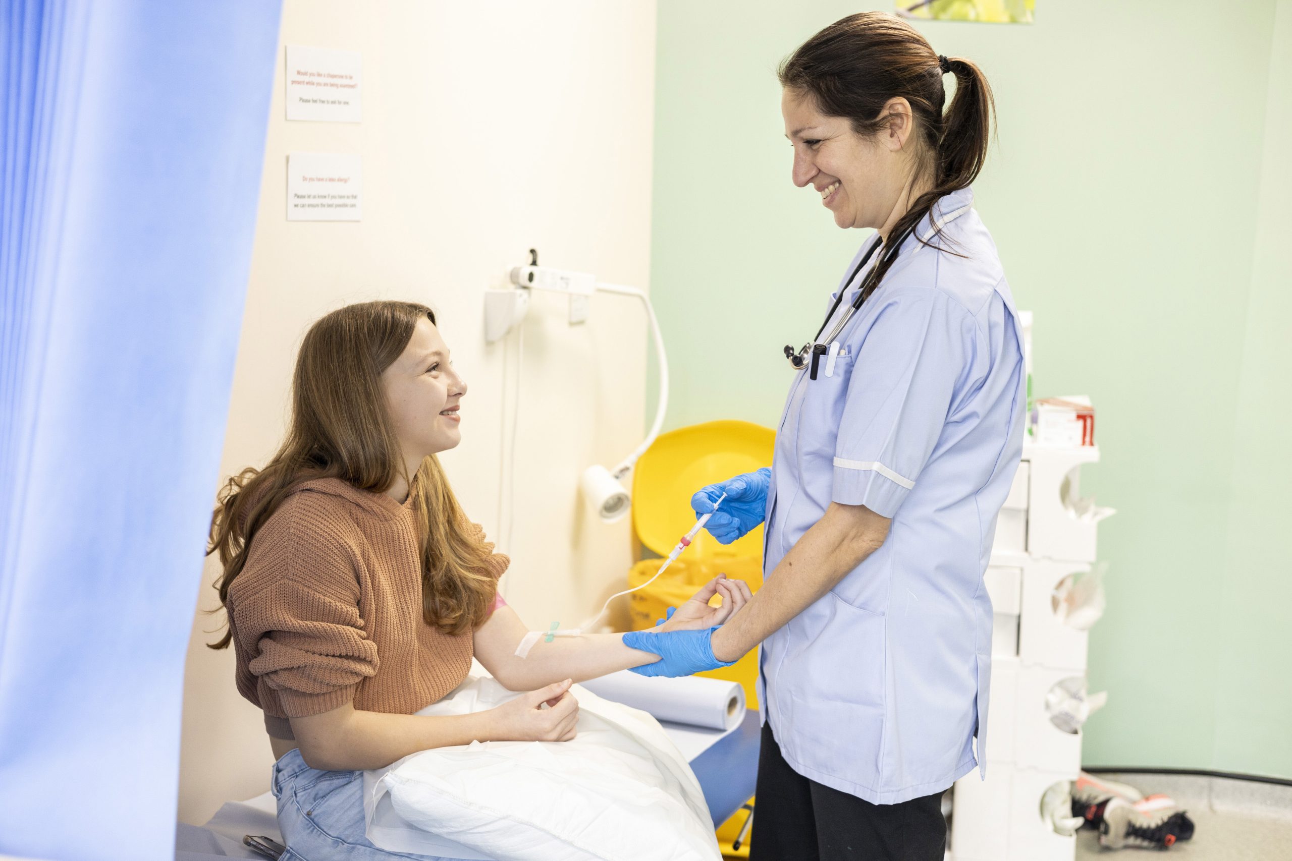 Nurse giving injection to a young patient - Contigo Healthcare Recruitment